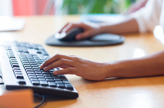 close up of female hands with keyboard and mouse