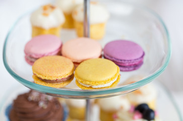 close up of cake stand with macaroon cookies