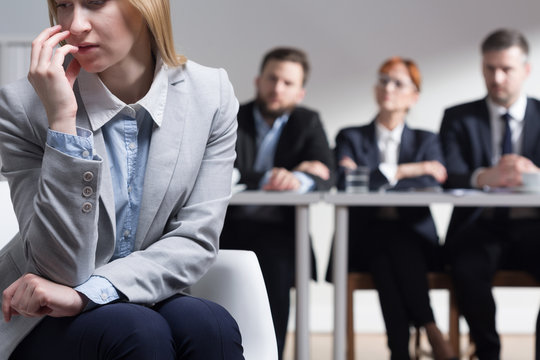 Young woman too stressed to talk with interviewers on job interview
