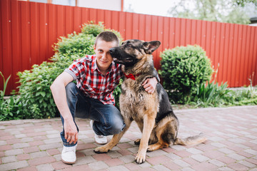 man playing with german sheep-dog