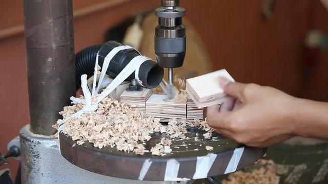 Wood boring on drill press machine in action