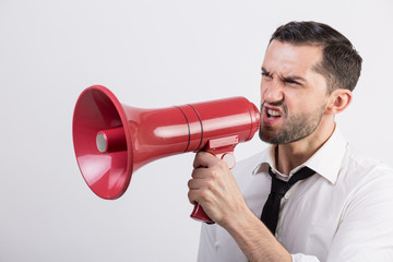 Business man holding a red loudspeaker