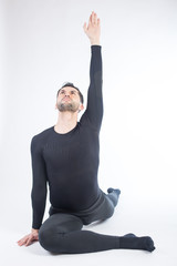 Young male performing yoga