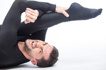 Young male performing yoga