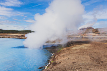 Hverir geothermal area in the north of Iceland near Lake Myvatn, with geothermal lake, looking like Blue Lagoon, Hot Mud Pots and great landscape in the Geothermal Area Hverir, summer day.