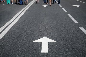 direction arrow on road and people