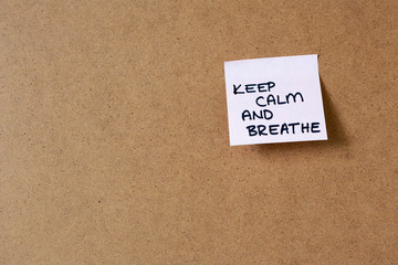 sticky note on cork  board, hand writing notes