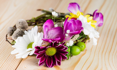 Spring composition with willow twigs wreath and fresh flowers on