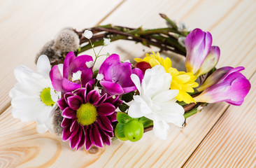 Spring composition with willow twigs wreath and fresh flowers on