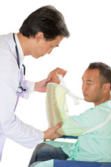 Fototapeta premium Doctor checking the Broken arm of the patient.