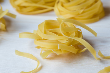 tagliatelle pasta on wooden table