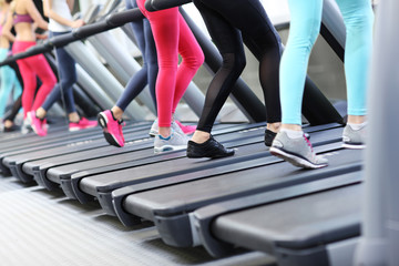 Fototapeta na wymiar Group of women jogging on treadmill