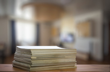 stack of old magazines on wooden table