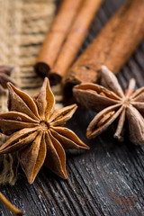 Cinnamon and anise on rustic wooden background