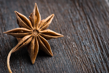 Anise on rustic wooden background
