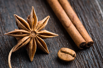 Cinnamon and anise on rustic wooden background