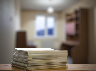 stack of old magazines on wooden table