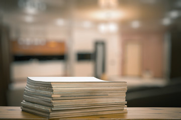 stack of old magazines on wooden table