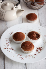 Muffins with spelt flour and cocoa in a wooden box on a table, closeup..