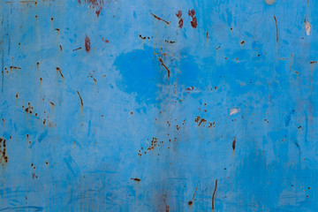 Old blue cracked paint on metal background