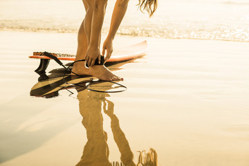 Young woman preparing to surf, La Jolla, San Diego, California, USA
