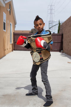 Boy wearing boxing gloves with medals