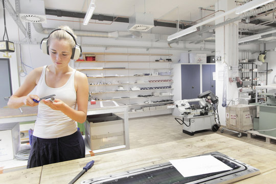 Technician working in mechanical workshop within optical laboratory