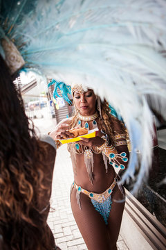 Samba dancers having hot dogs, Rio De Janeiro, Brazil