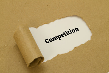 Competition word written under torn paper.