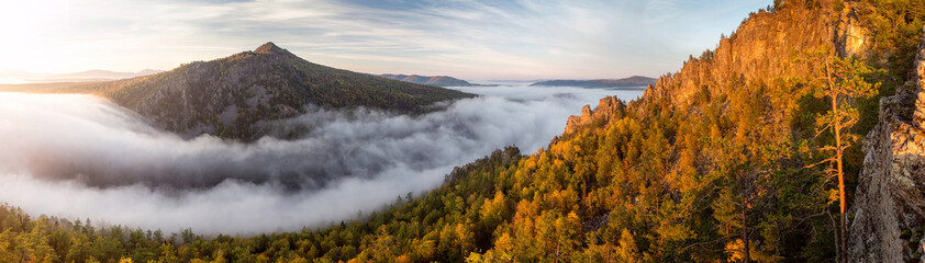 Great view of the foggy valley with sunrise. South Ural mountain