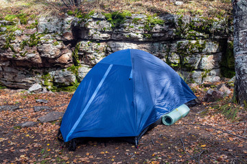 tent in forest near big rocks