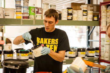 Worker mixing ink in screen print workshop