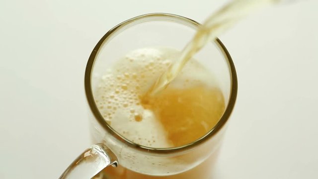 Top view of pouring beer into a glass