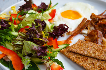 Healthy breakfast, bekon with salad and egg