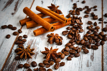 Coffee beans, cinnamon, star anise on old wooden table