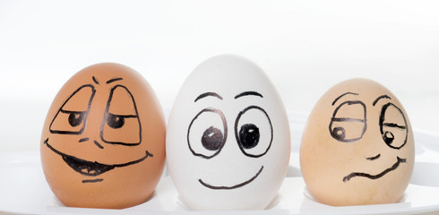 funny easter eggs / Three funny easter eggs in front of a bright background