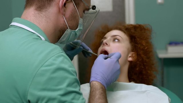 Smiling woman visiting dentist. Slow motion. Close up