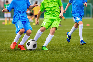 Fototapeta na wymiar Young boys playing youth soccer football game