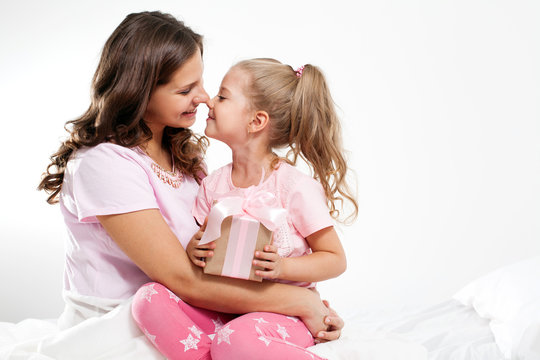 Happy family. Mother and daughter with pink gift box. Mother's day 