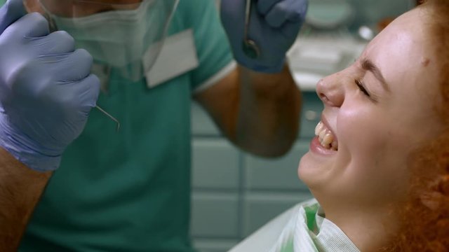 Smiling woman visiting dentist. Slow motion. Close up