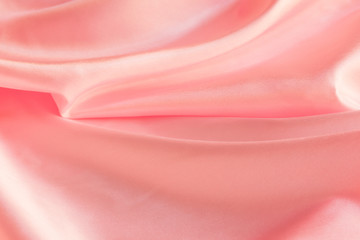 Obraz premium Shiny Pink silky fabric folds background texture