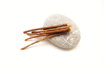 Liquorice root lying on a white background
