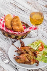 roast quail and a glass of white wine