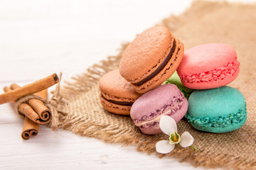 macaroon and cinnamon sticks on table