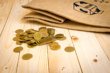 Gold coins on the background of wood