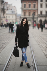 Beautiful brunette young woman posing on the street in old city