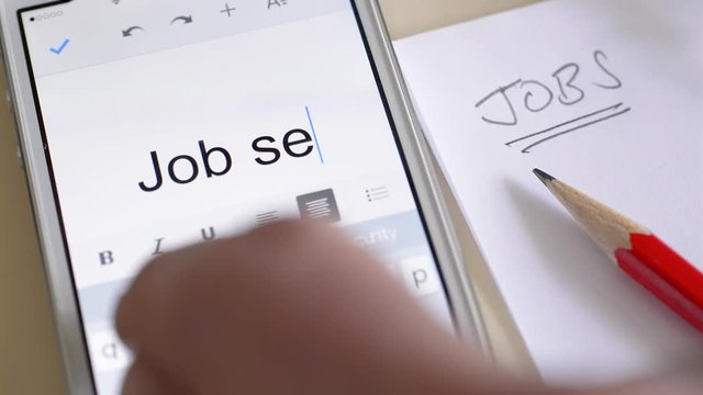 Unemployment and looking for work. Writing the words job seeker on a mobile phone.