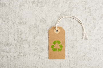 Recycling symbol on brown paper tag. Concept of environmental awareness, eco lifestyle and green eco-friendly shipping. - 106910256