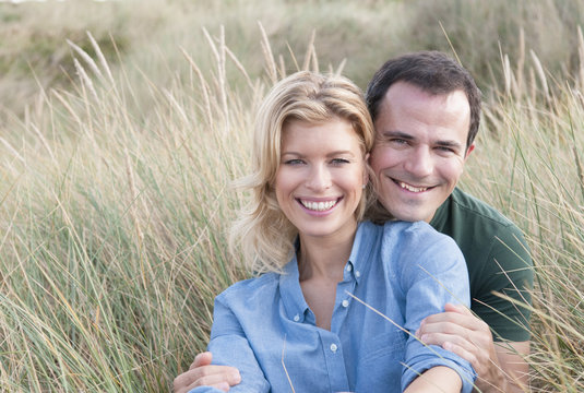 Portrait of mid adult couple in sandunes, Thurlestone, Devon, UK