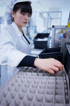 Worker at small parts manufacturing factory in China